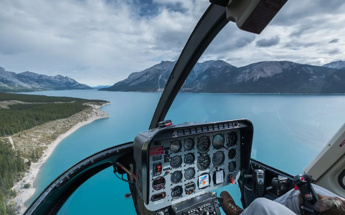 The cockpit of a helicopter on a flight over the Canadian Rockies